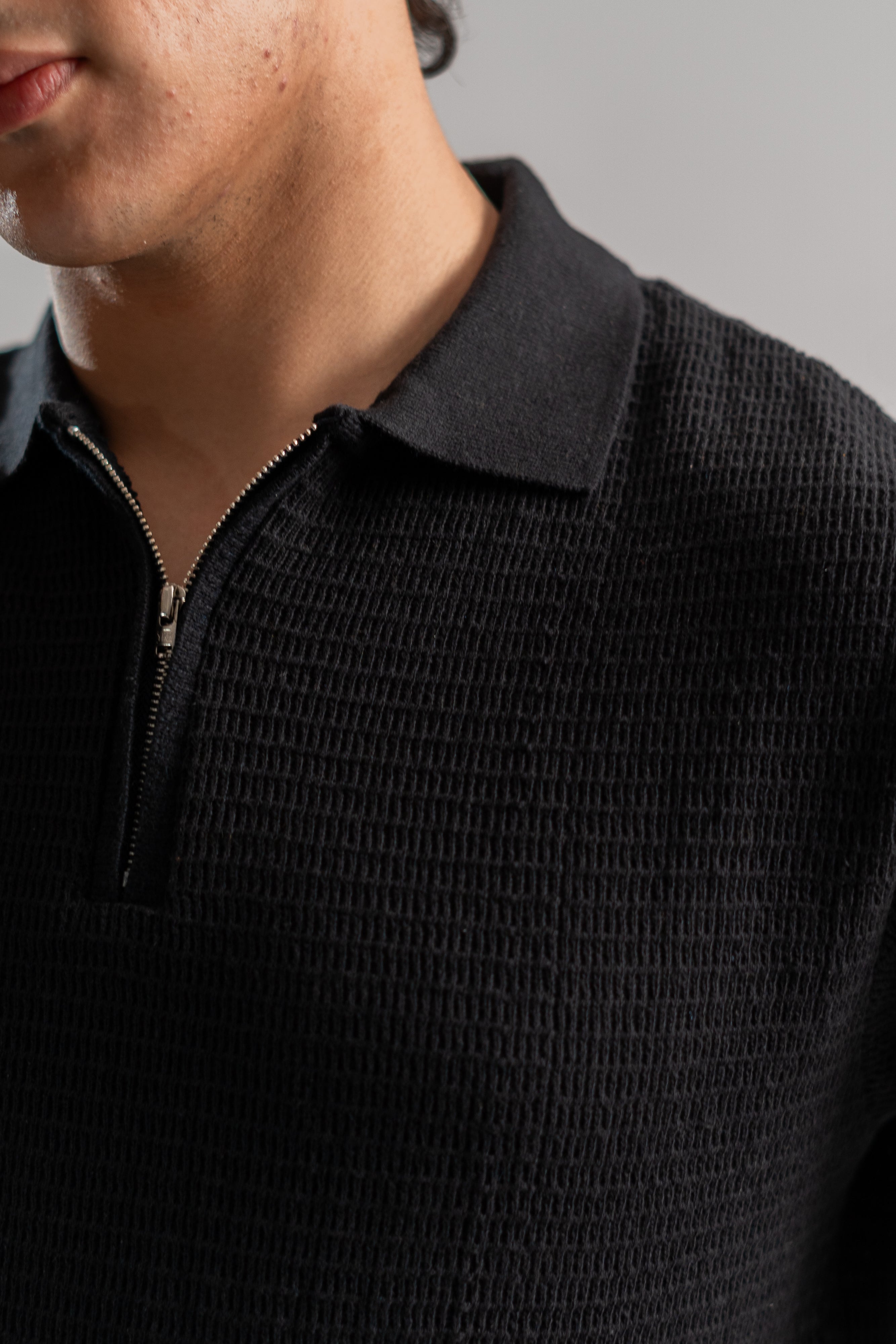 Black textured knit polo